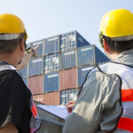 Workers checking shipping containers